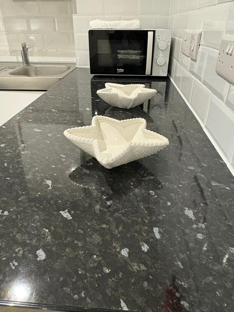 Modern kitchen countertop with dark granite-sty...