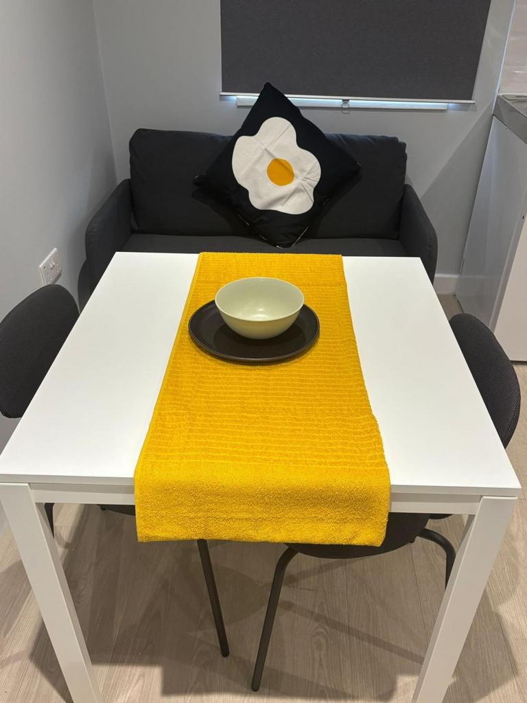 Compact and stylish sitting area with a neat di...