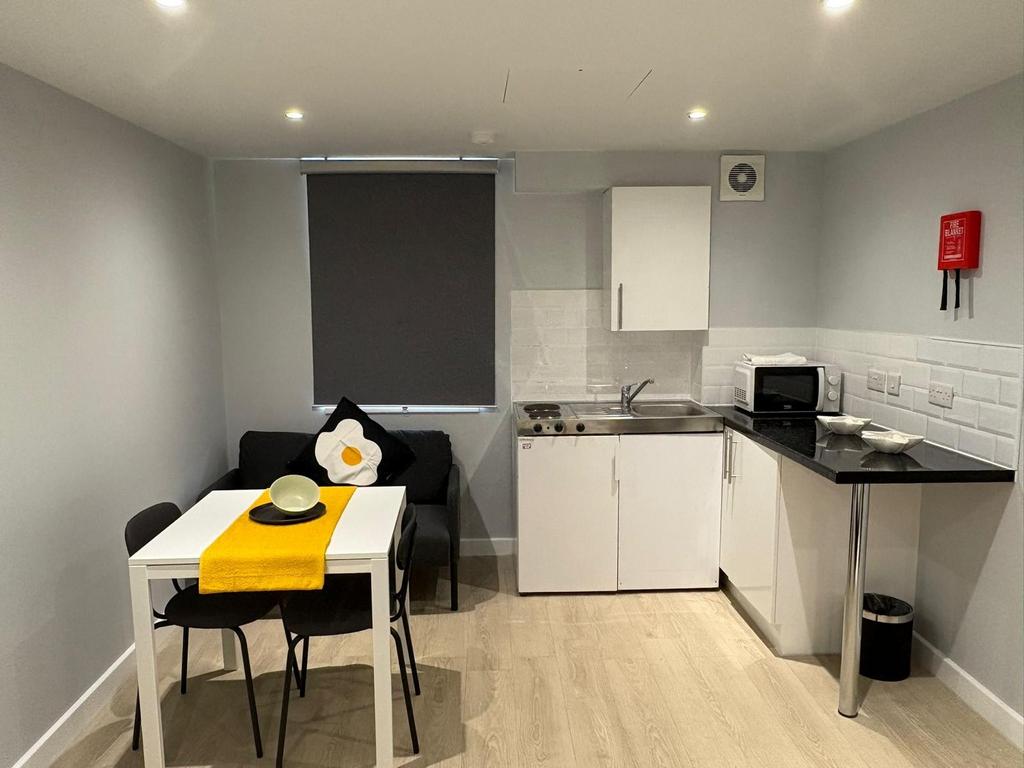 Bright, modern kitchenette with a compact dinin...