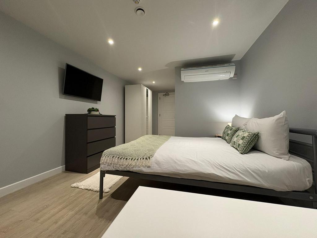 Modern, tidy bedroom with a comfortable double ...