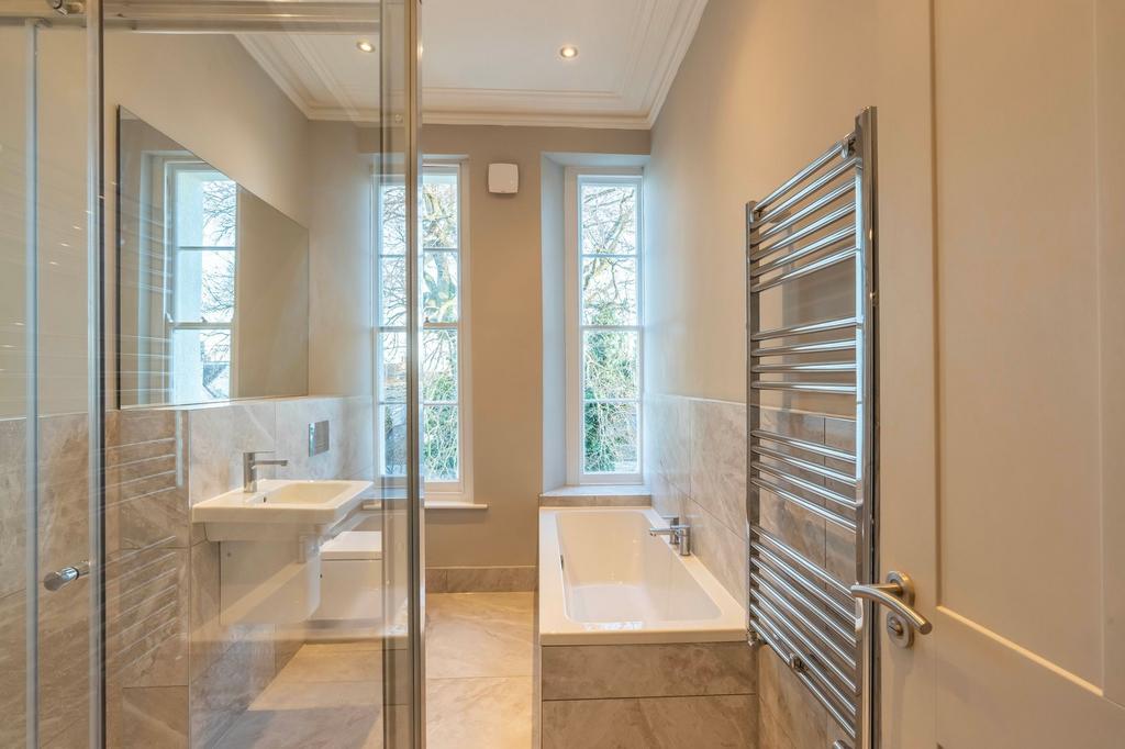 Bright, modern bathroom with a built-in bathtub...