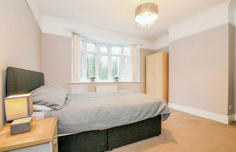 Bright, neutrally decorated double bedroom with...