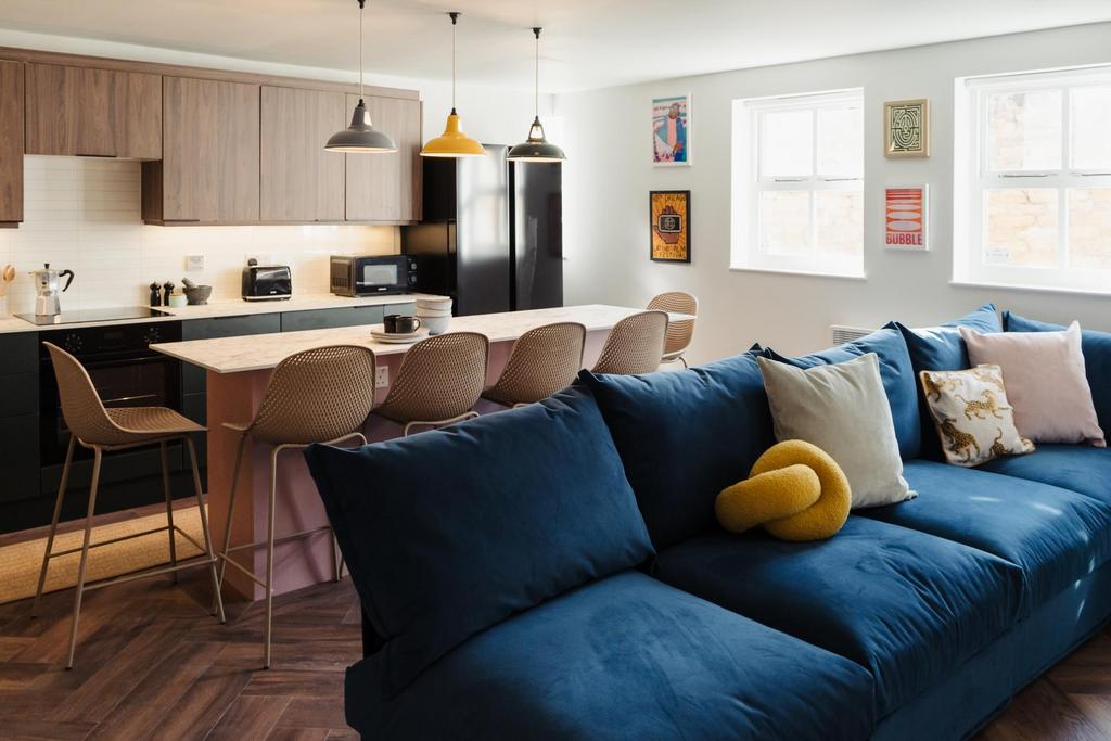 A stylish and spacious living room featuring a ...
