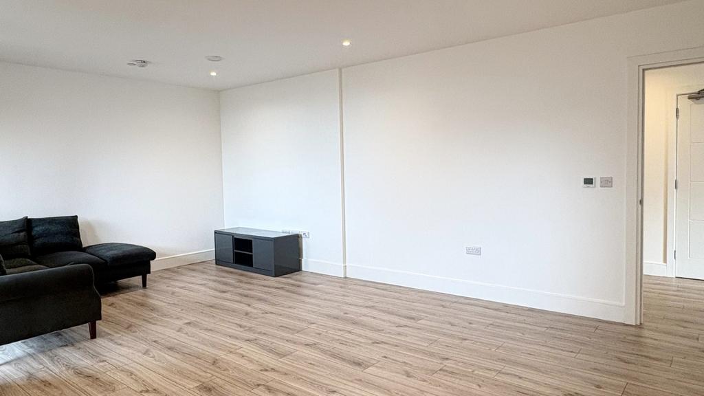 Bright, modern living room with light wood floo...