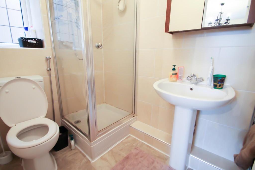 Bright, well-kept bathroom with a glass-enclose...