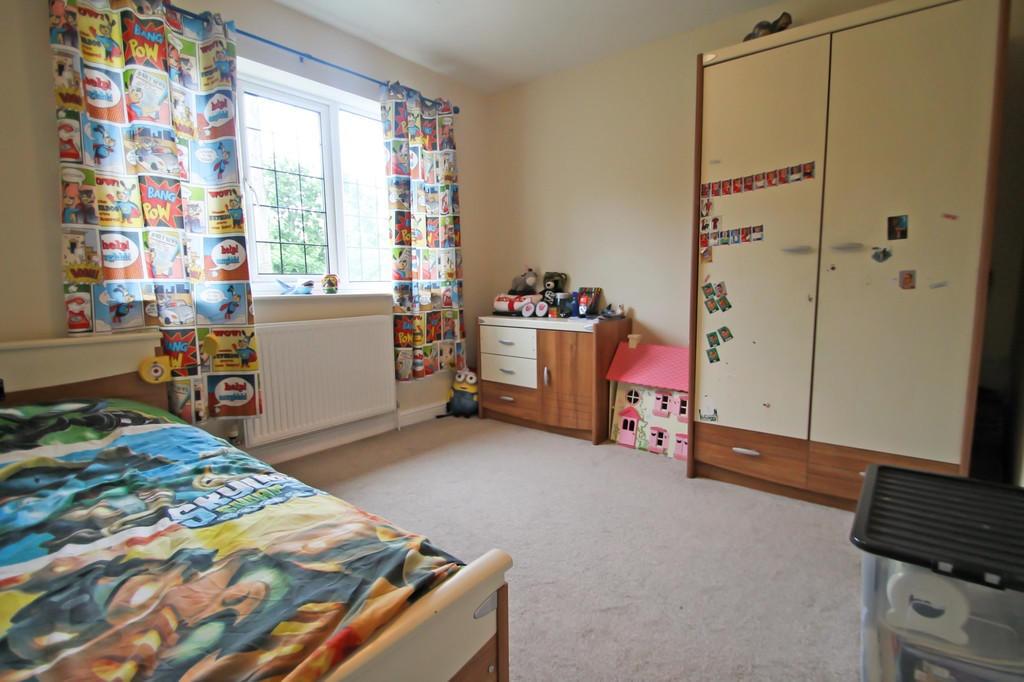 Bright, tidy bedroom with a large window, colou...