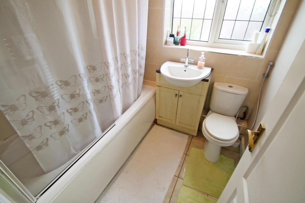 Bright, well-kept bathroom with a shower-over-b...
