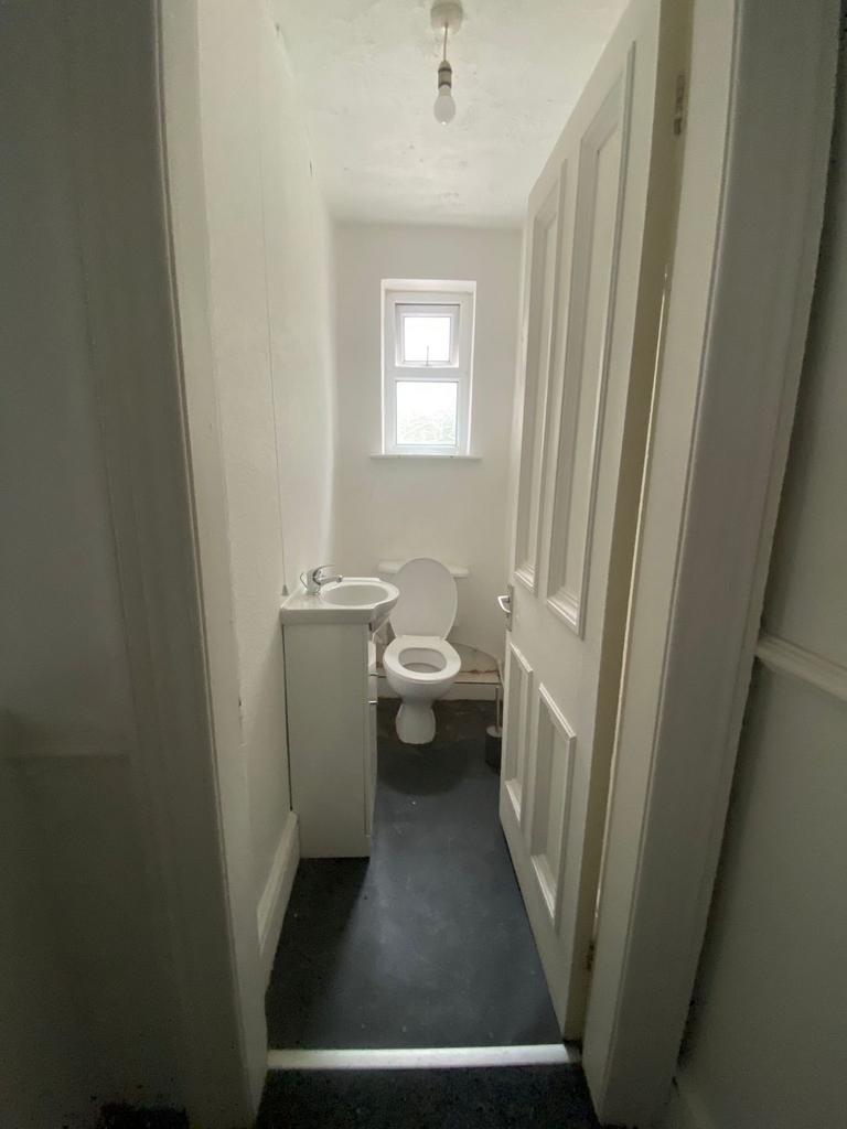 Compact downstairs WC with a simple white basin...