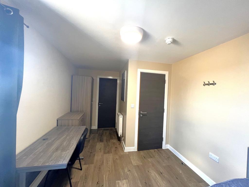 Well-presented single bedroom with a long study...