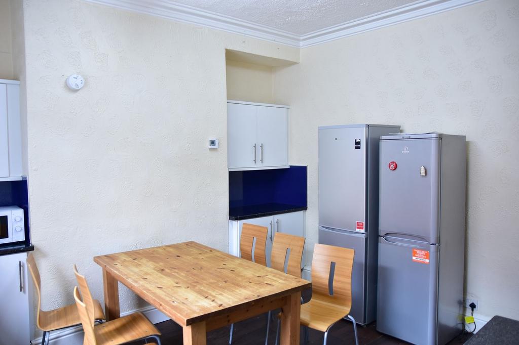 A well-maintained kitchen with a wooden dining ...