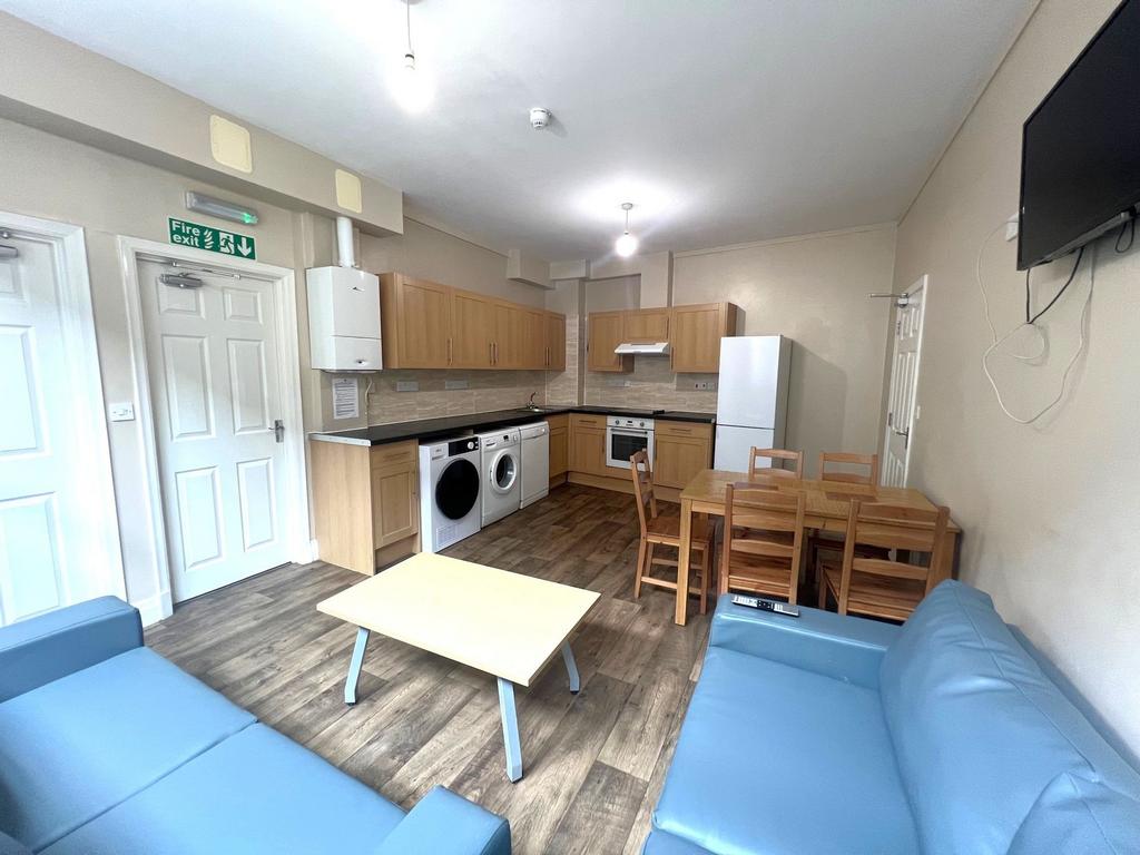 Bright communal lounge with an open-plan kitche...