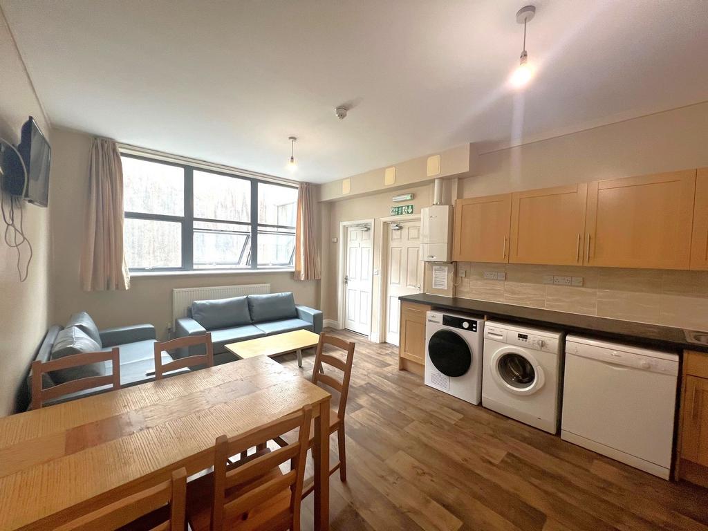 Bright open-plan communal lounge with large win...