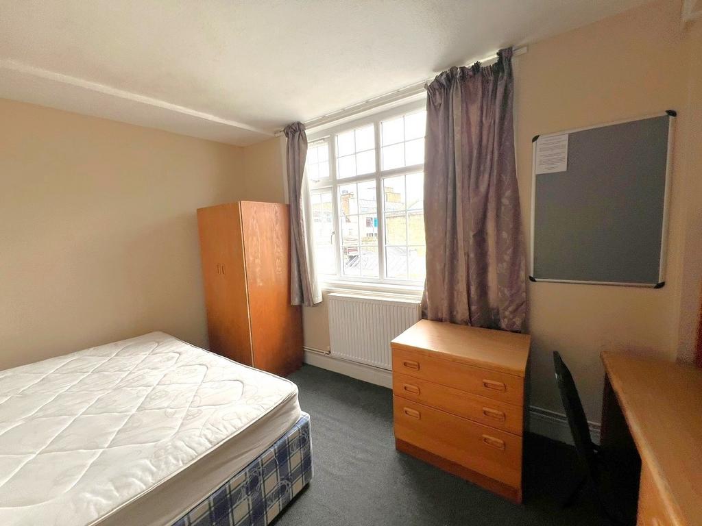 A bright and inviting double bedroom featuring ...