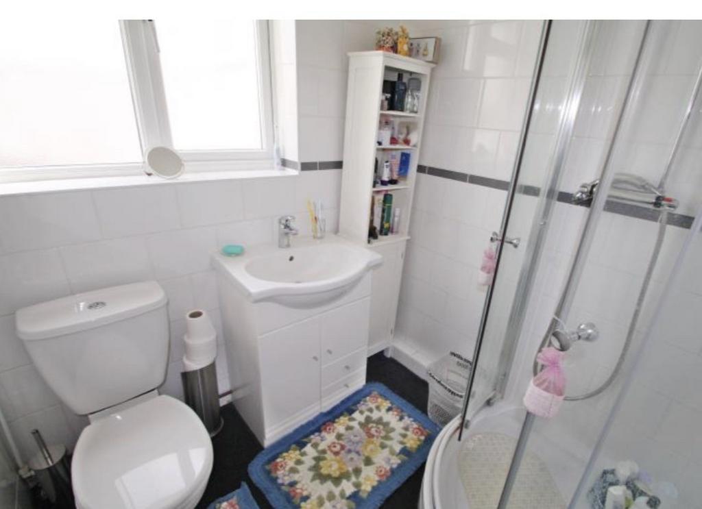 Bright, well-kept bathroom with a corner shower...