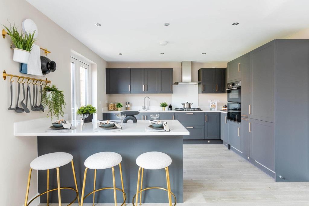 A breakfast bar in the kitchen offer space to...