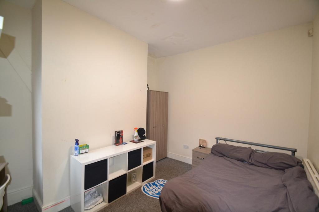 This inviting double bedroom features a cozy la...