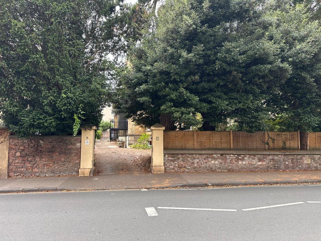 Attractive gated frontage with a leafy entrance...
