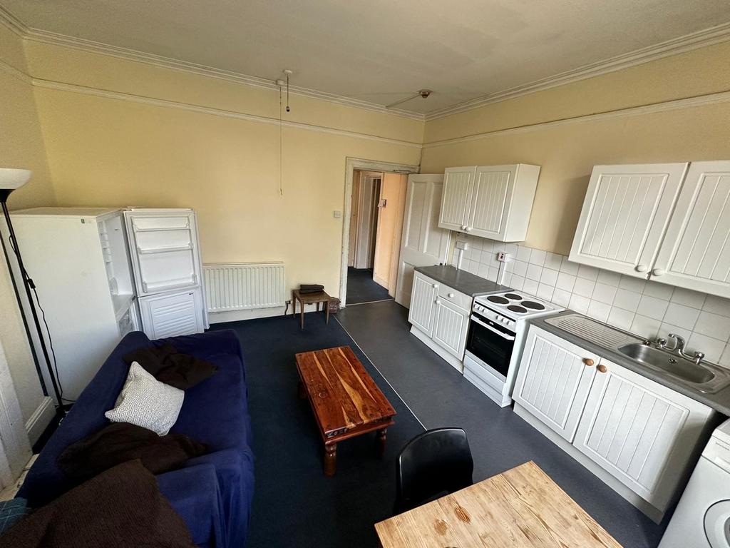 A spacious and tidy kitchenette with ample stor...