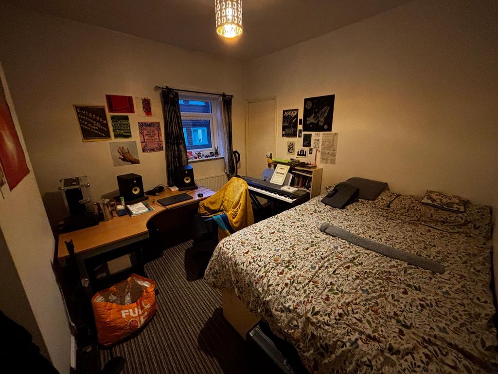 Cozy double bedroom with a large bed, work desk...