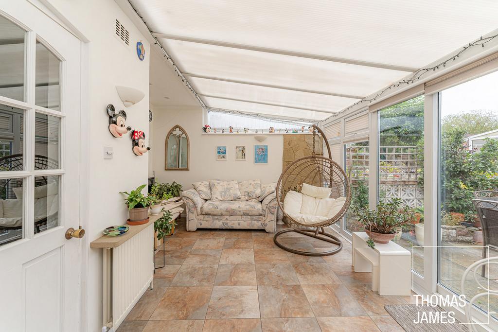 Conservatory interior, french doors leading to garden