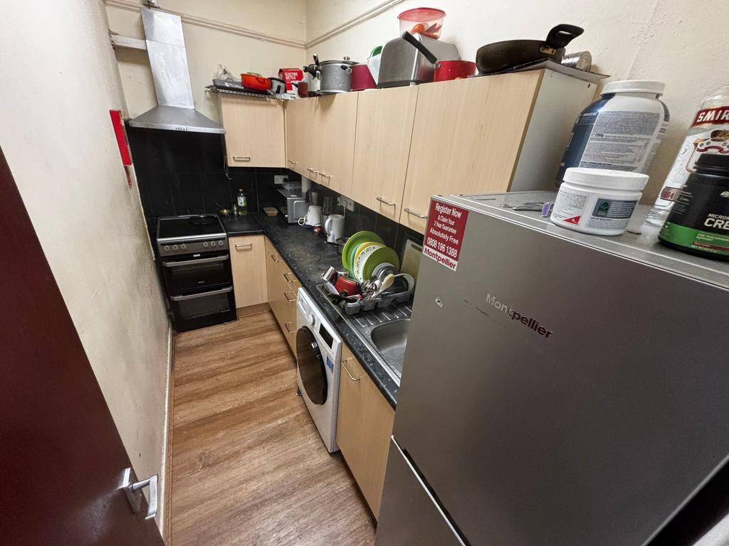 Compact galley kitchen with fitted base and wal...