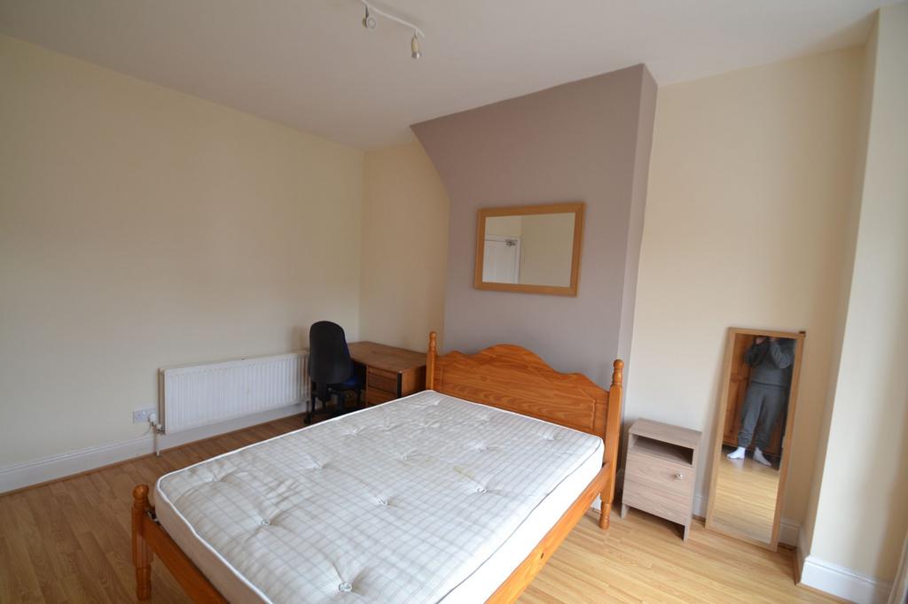 Bright and tidy bedroom featuring a wooden bed ...