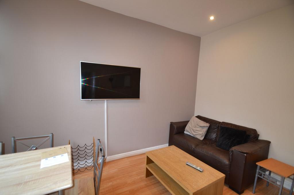 A contemporary living room featuring a wall-mou...