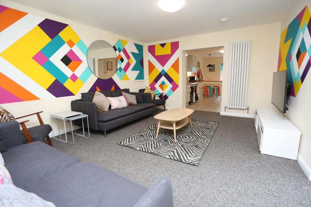 Bright, modern communal lounge with bold geomet...