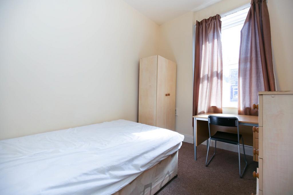 A bright and tidy double bedroom featuring a co...