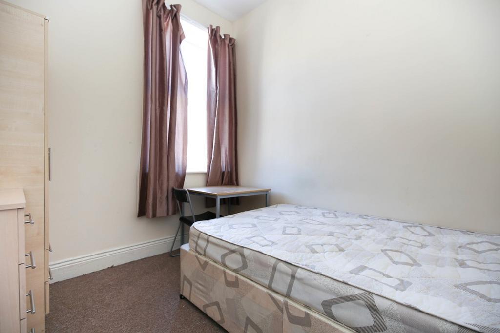 A bright and tidy double bedroom featuring a co...