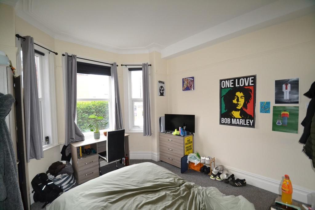 This inviting double bedroom features large win...