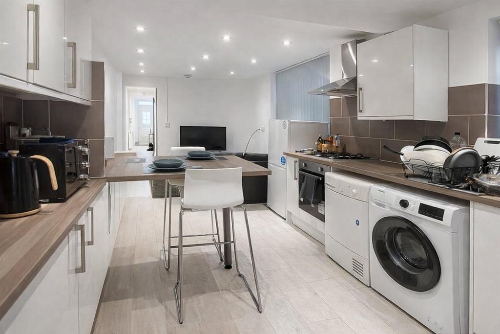 Modern galley kitchen with wood-effect worktops...