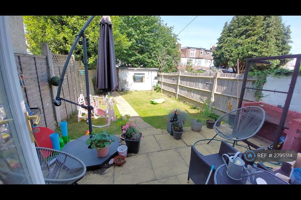 Fenced Back Garden With Shed And Lawn