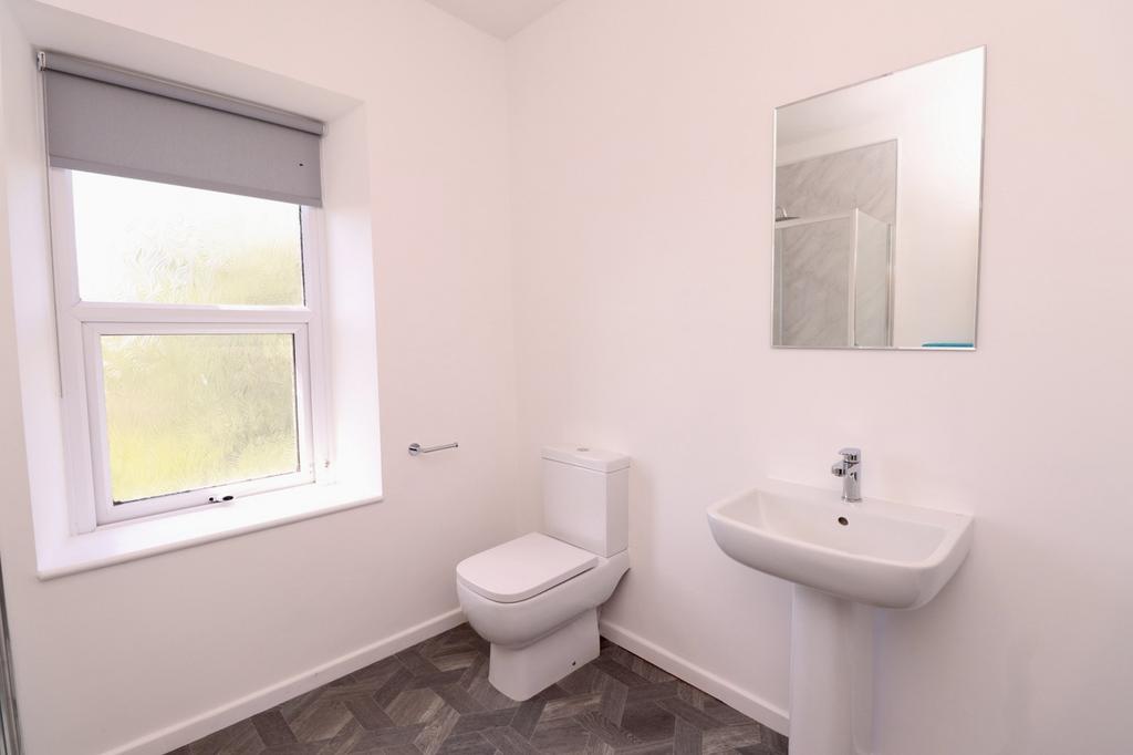A clean and modern bathroom featuring a bright ...