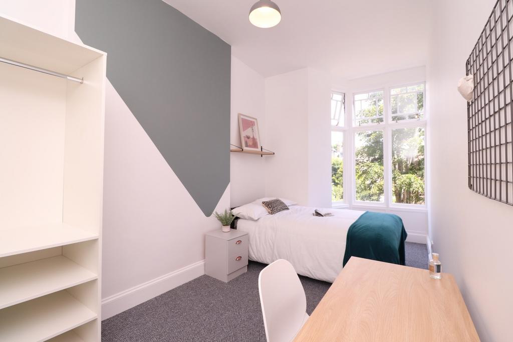 A bright and inviting double bedroom featuring ...