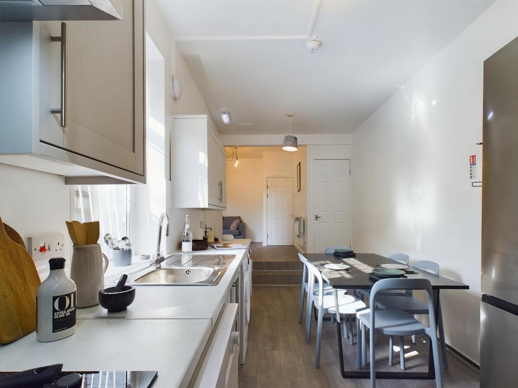 Modern kitchen space featuring sleek cabinetry,...