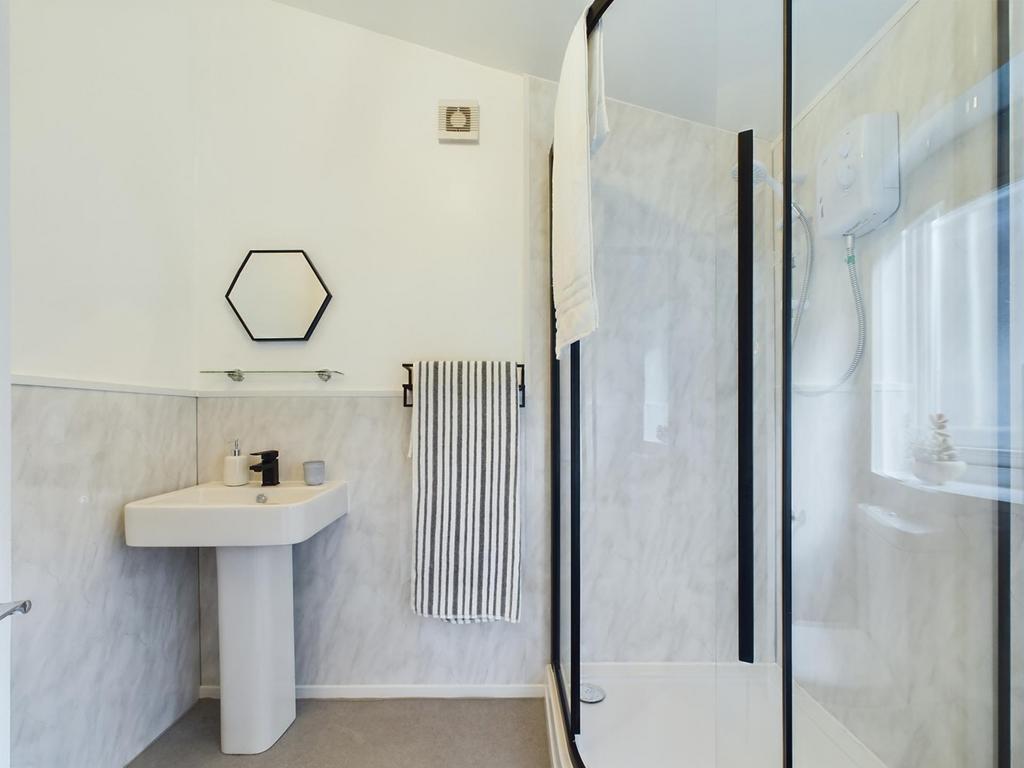 This modern bathroom features a spacious design...