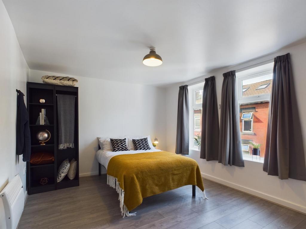 This inviting double bedroom features large win...