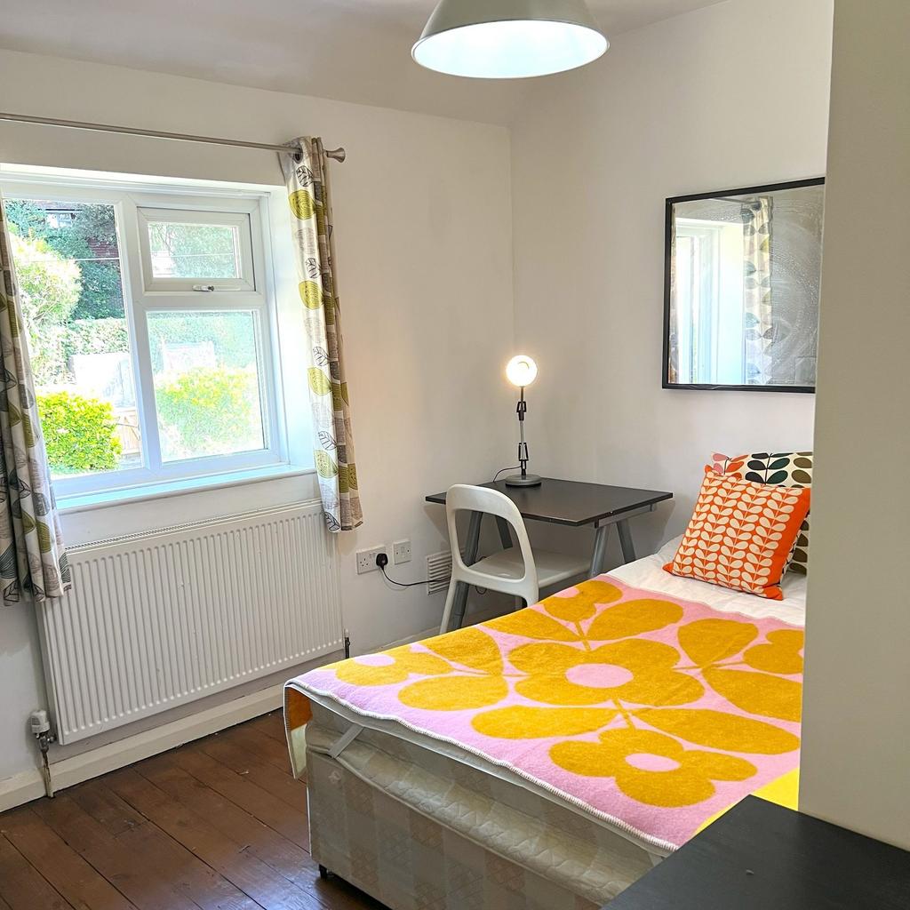Bright, simply furnished single bedroom with a ...