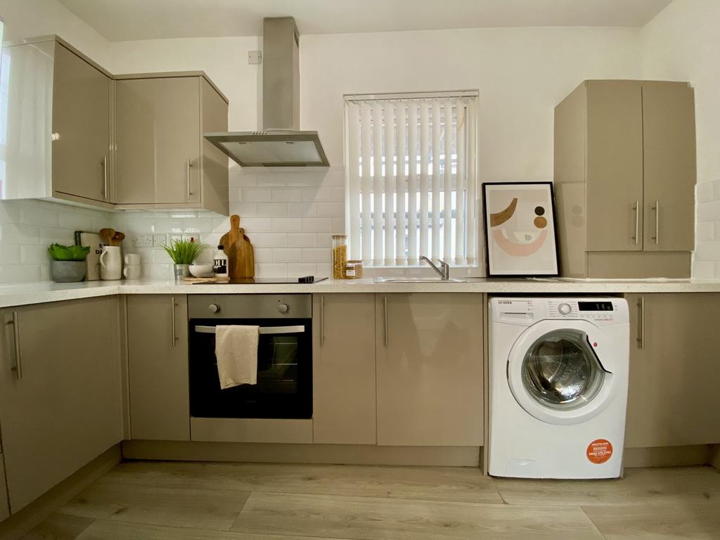 A modern and tidy kitchenette featuring sleek c...