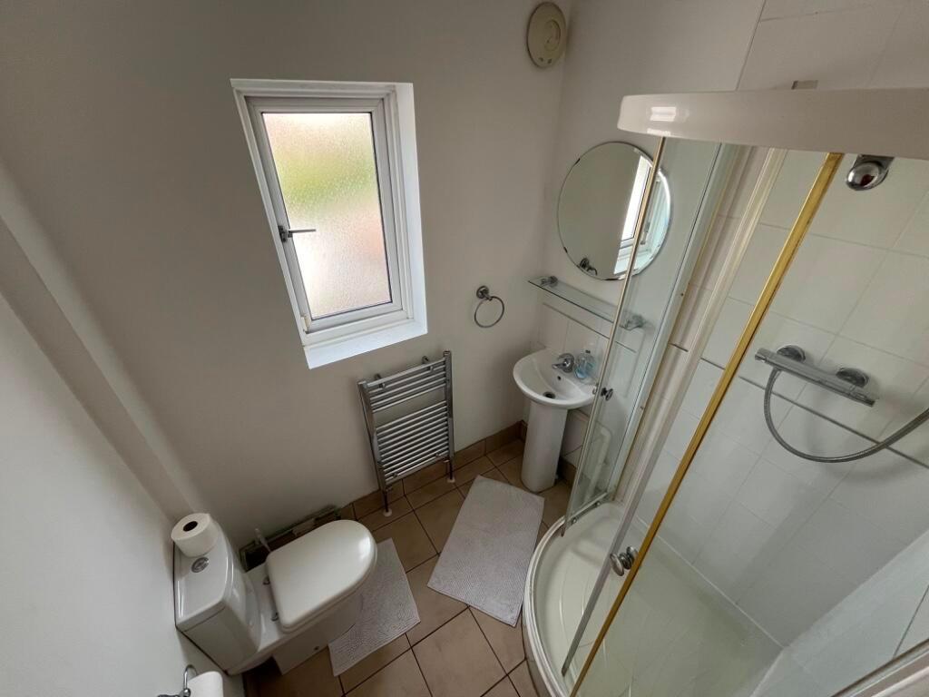 Clean, well-maintained bathroom with a corner s...
