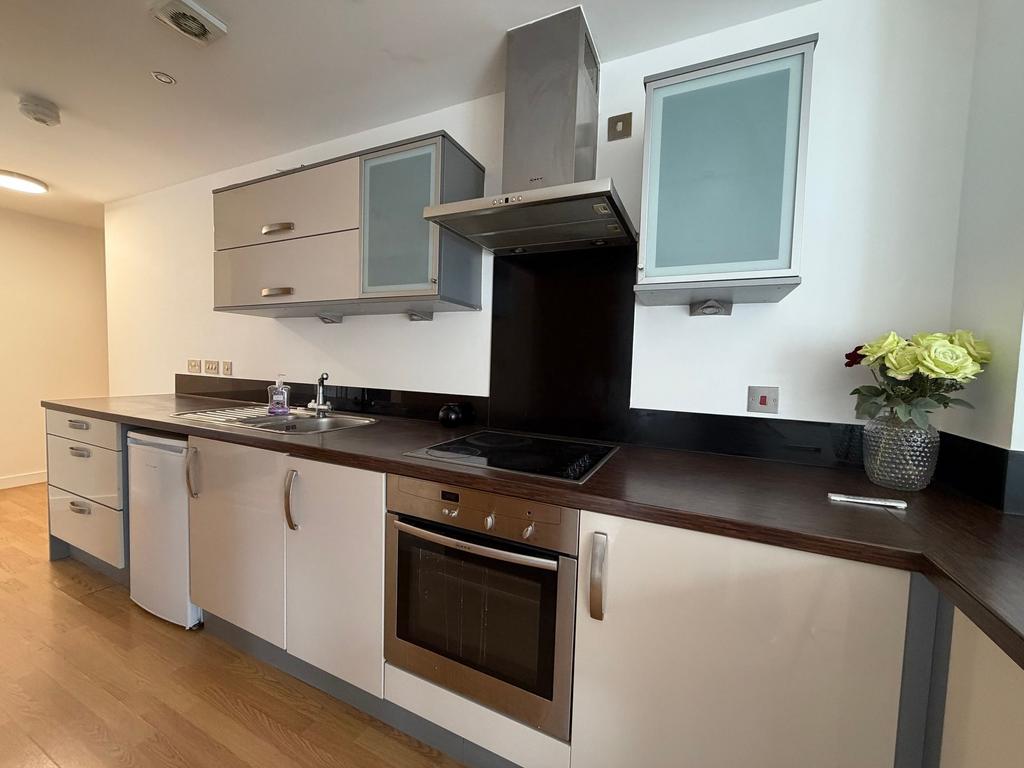 Bright modern kitchen with dark wood countertop...