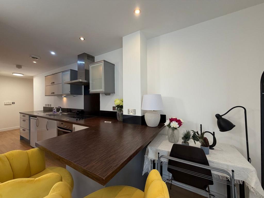 Contemporary open-plan kitchen with a dark wood...