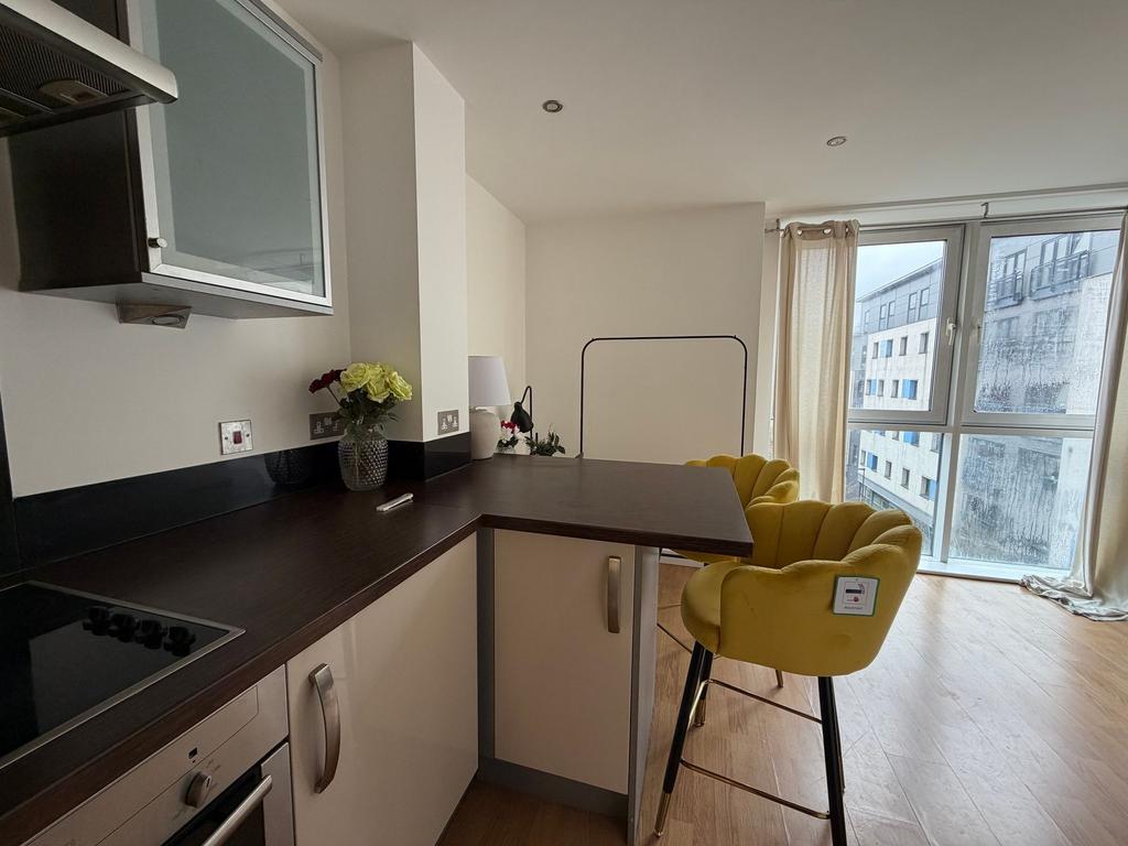 Modern open-plan kitchen with a dark wood break...