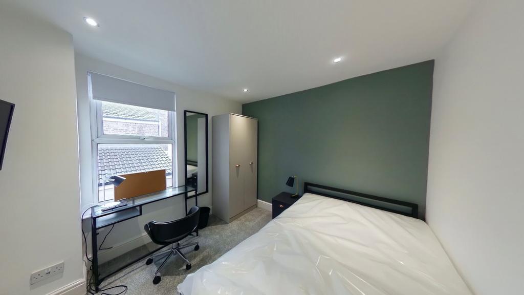 A bright and modern double bedroom featuring a ...