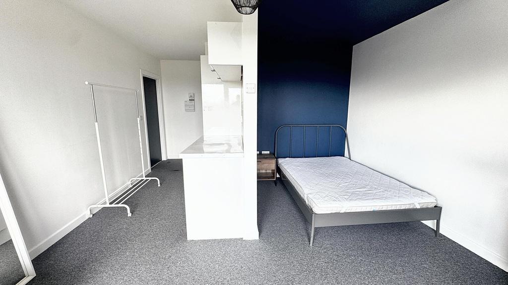 A spacious master bedroom with a double bed and...