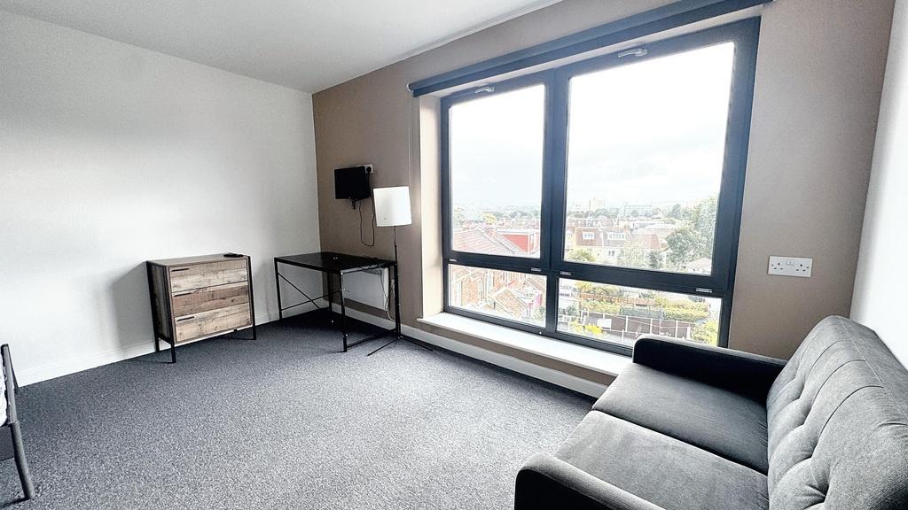 A bright, modern living room with large windows...