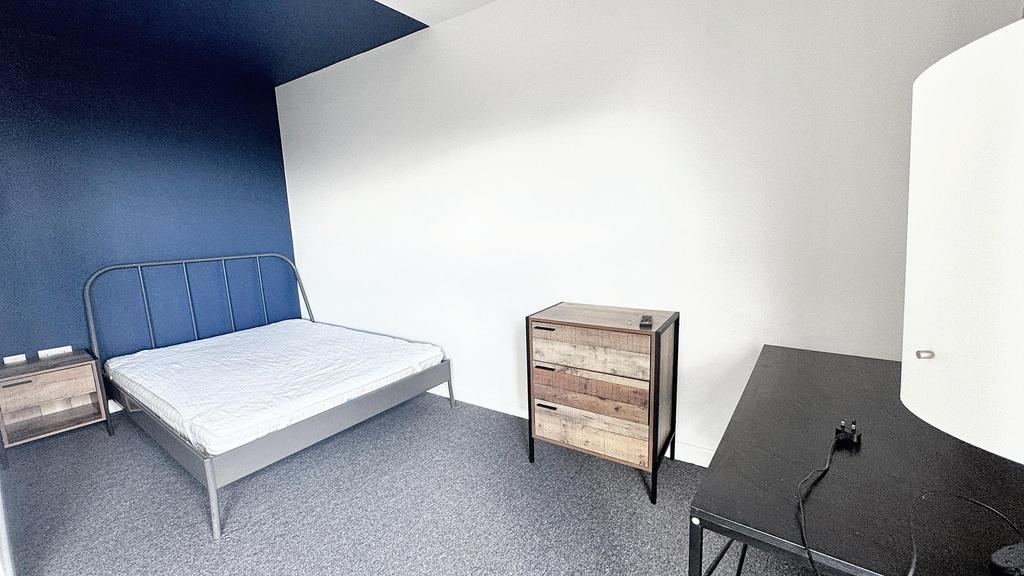 A simple, clean individual bedroom featuring a ...