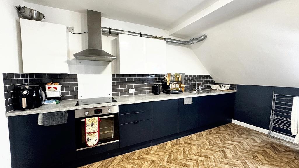 Modern kitchen with sleek white and navy cabine...