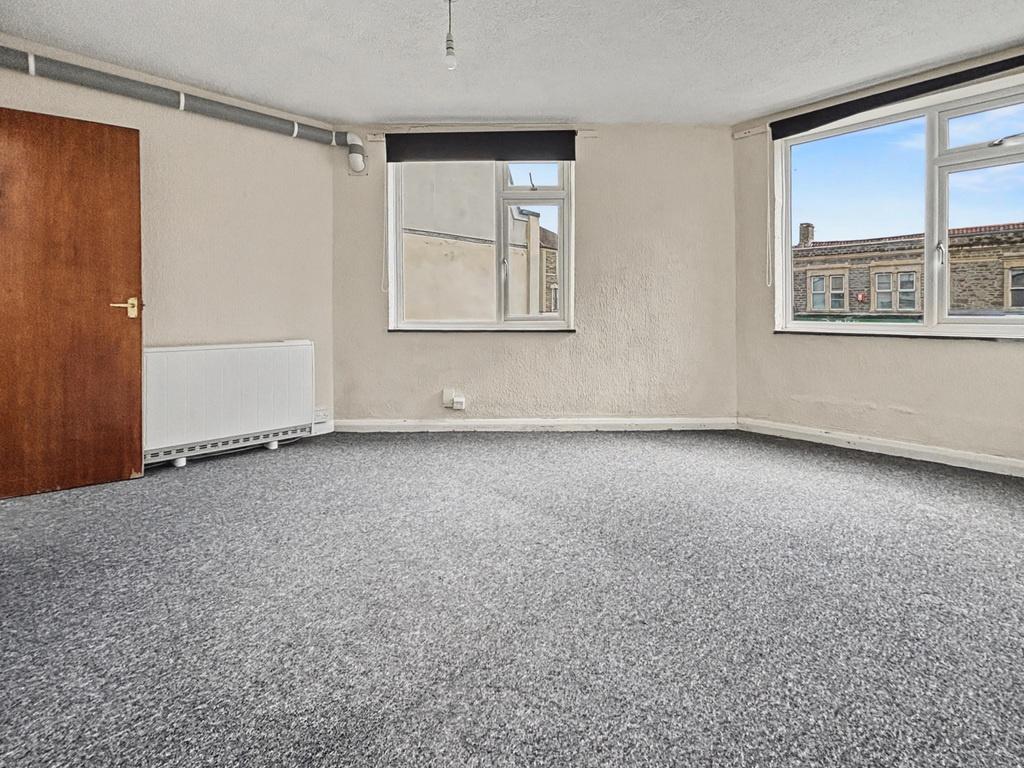 Bright, neutral living room with large windows,...